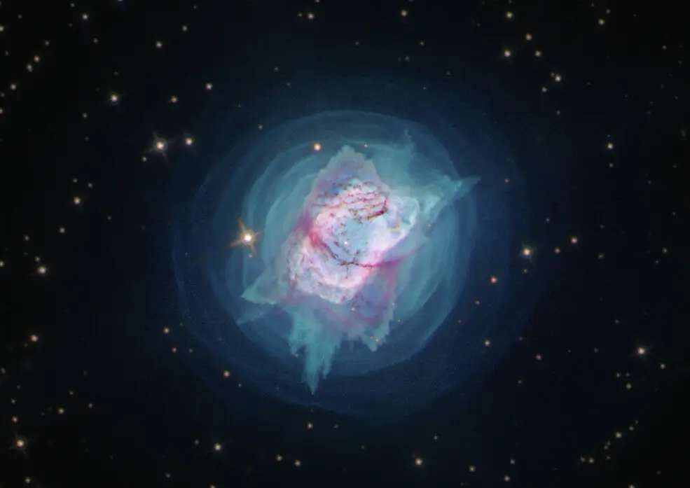 A glowing planetary nebula in shades of teal and pink against black space