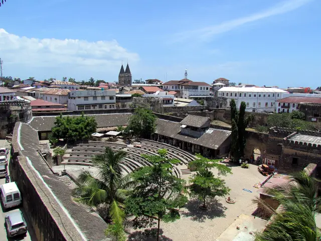 Looking down into the walled courtyard and amphitheatre of the Old Fort, with Stone Town rooftops beyond