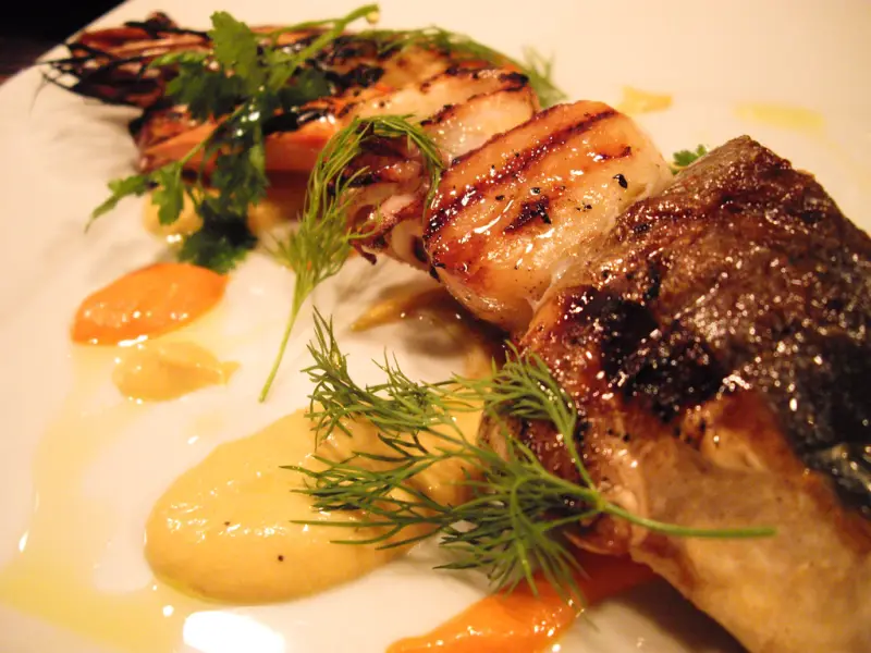 Grilled prawns, squid and fish piled on a platter