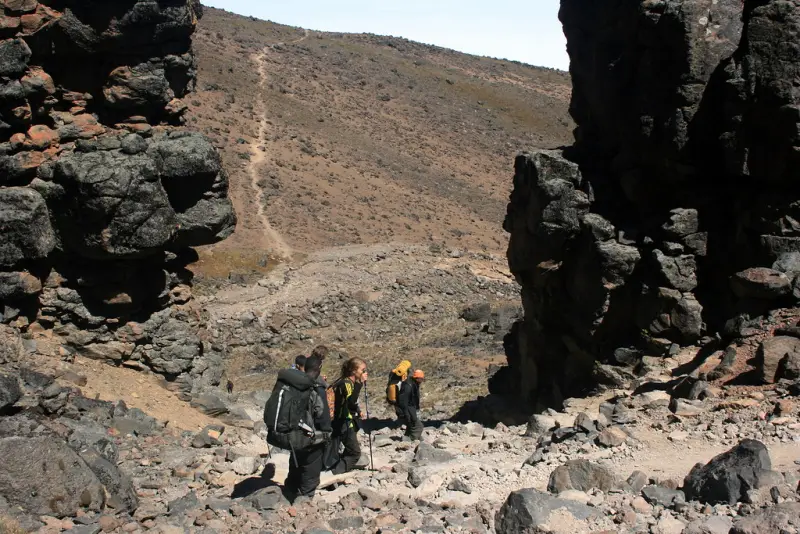 Climbers walking between the volcanic rocks near Lava Tower