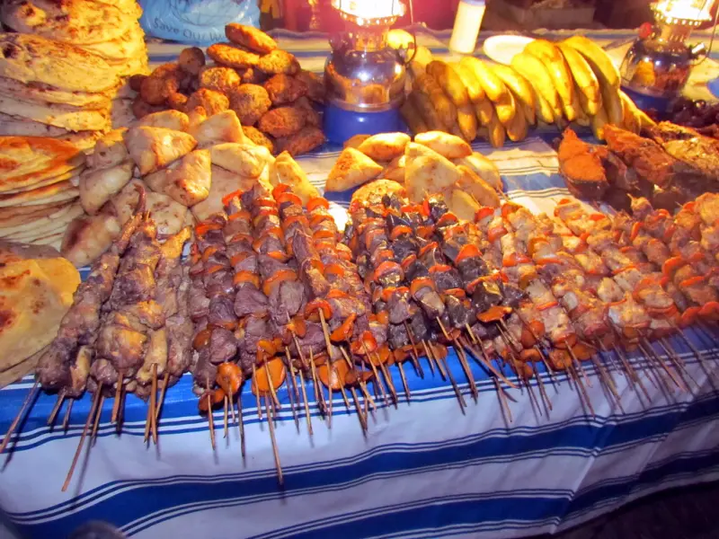 Seafood skewers and breads lit by lanterns at the Forodhani night market